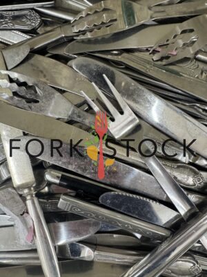 Assorted Worn Stainless Steel Knives And Forks In A Drawer