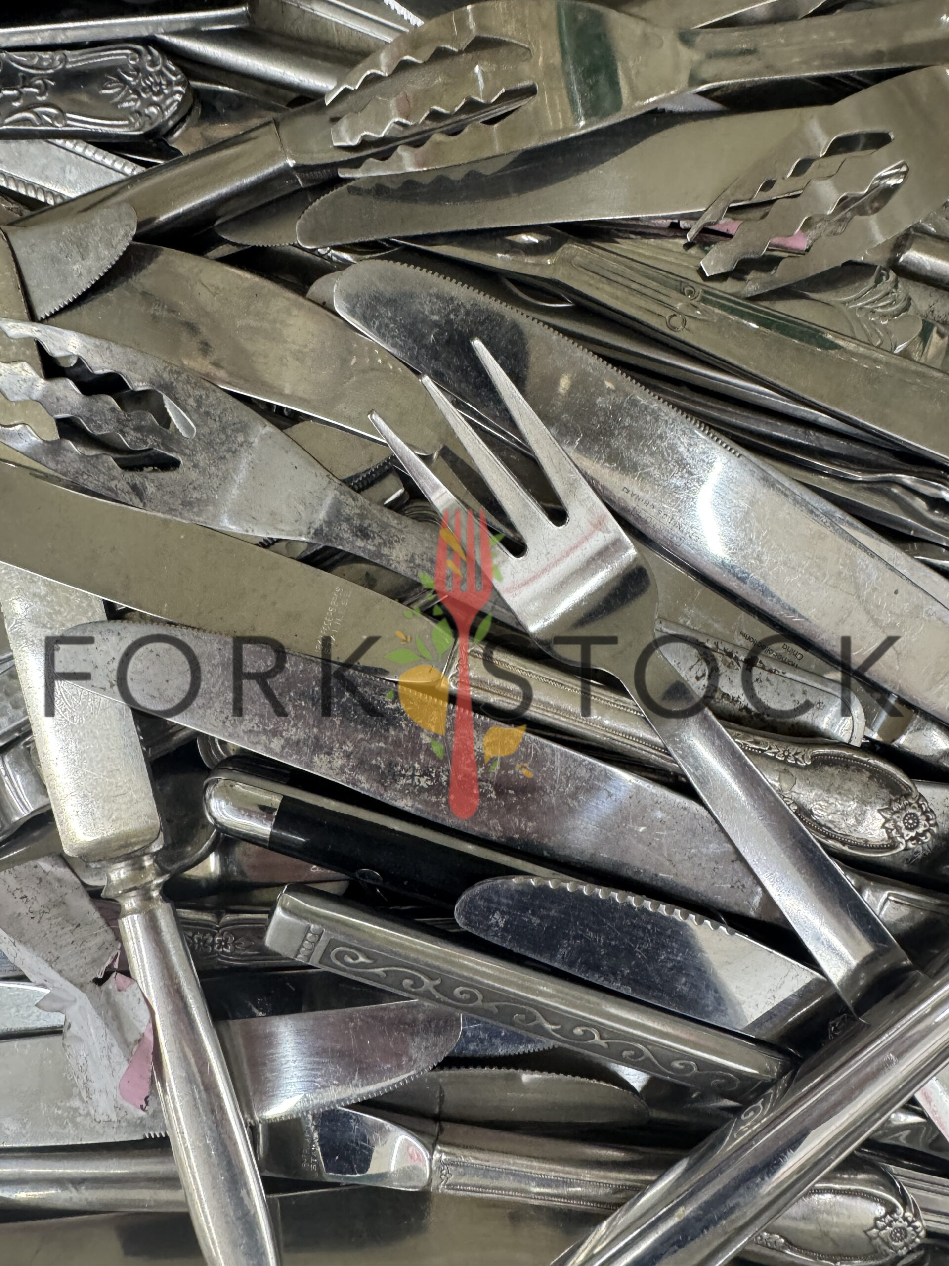 Assorted Worn Stainless Steel Knives And Forks In A Drawer