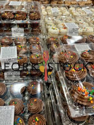 Tables Of Chocolate and Vanilla Cupcake Trays On Display