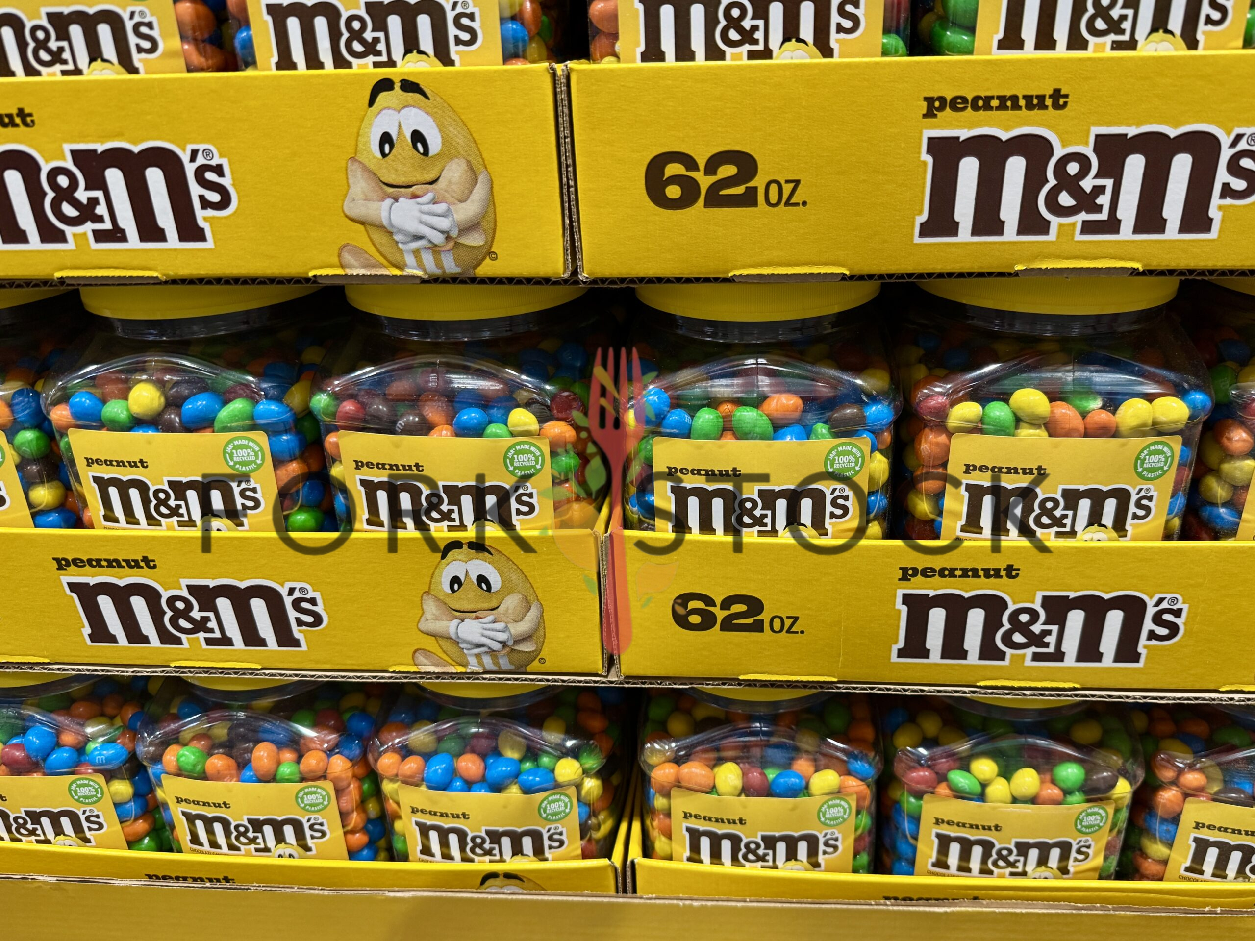 Stacked Trays Of 62oz Peanut M&M's Candy Tubs