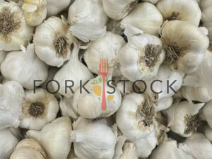 Several Garlic Gloves For Sale At A Grocery Store