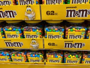Stacked Trays Of 62oz Peanut M&M's Candy Tubs