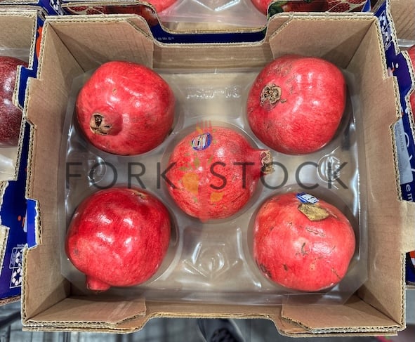 A Box Of Pomegranates On Display At A Warehouse Store