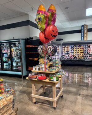 A Halloween Themed Bakery Display With A Variety Of Cakes