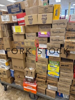 Chocolate And Candy Stacked On A Store Cart Ready For Stocking Shelves