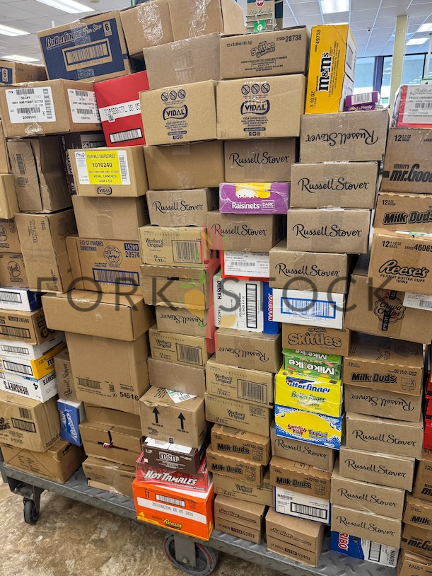 Chocolate And Candy Stacked On A Store Cart Ready For Stocking Shelves