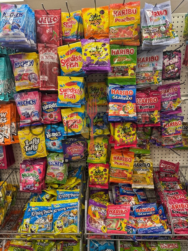 Various Candy On Retail Hooks At A Discount Store