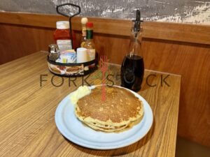 Dennys Pancakes On Booth Table With Syrup