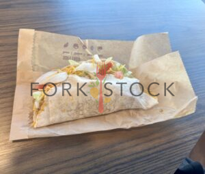 Taco Bell Beef Soft Taco Supreme On a Table With Bag